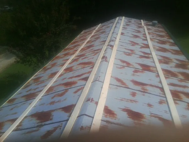 Rusted metal roof panels with new wood purlins before replacement — Storm Damage Roof Repair in Kershaw by Roofing Brothers