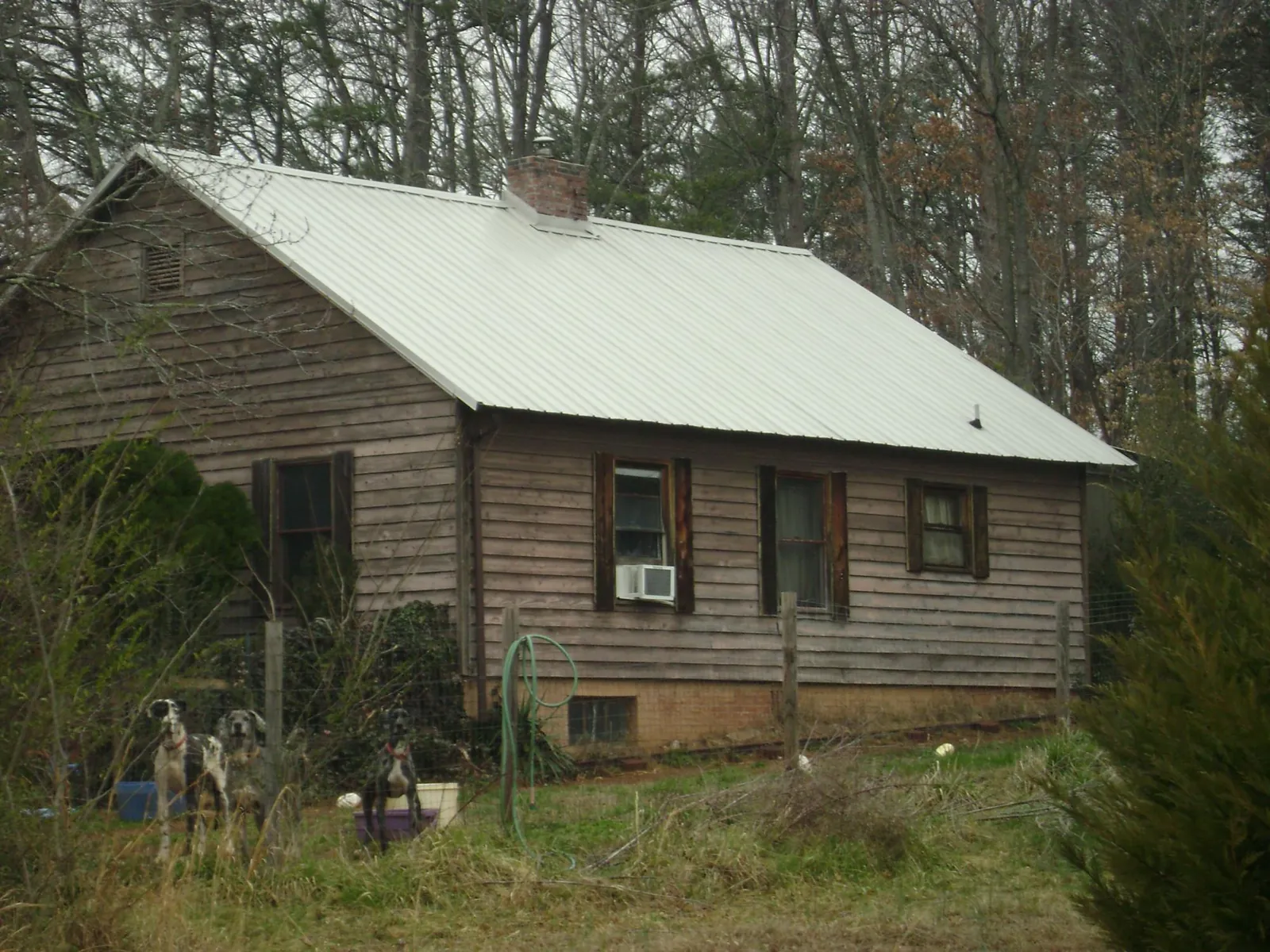 White metal roof on an old wood sided farmhouse, from a Metal Roof Installation job in Kershaw